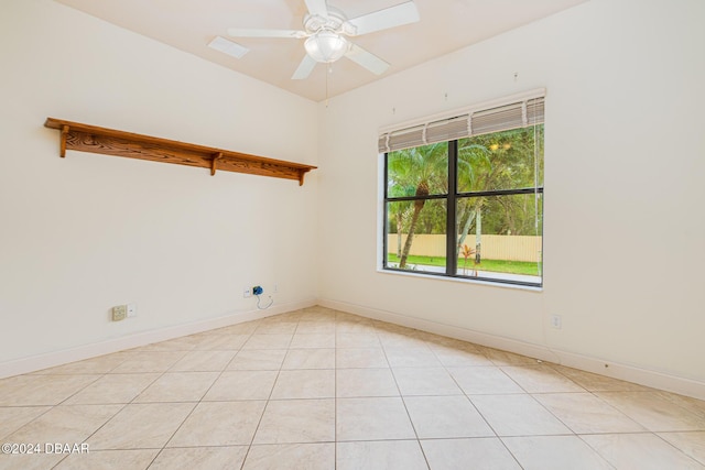 unfurnished room with light tile patterned floors, baseboards, and ceiling fan