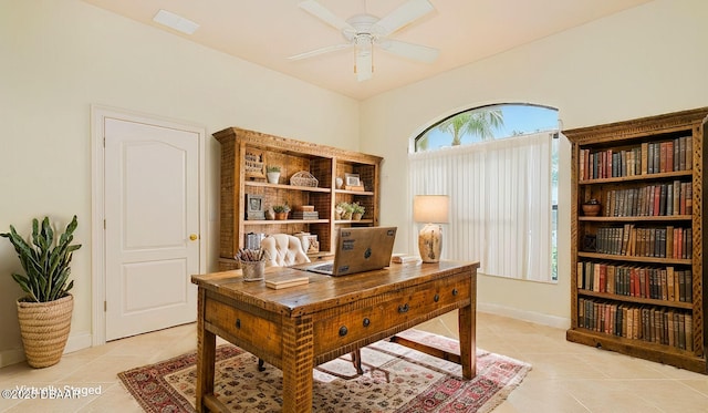 office space with light tile patterned floors, baseboards, and ceiling fan