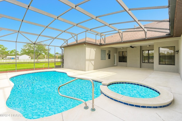 view of swimming pool featuring ceiling fan, fence, a lanai, a lawn, and a patio