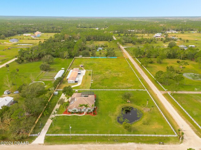 back of property with a swimming pool, glass enclosure, and a lawn