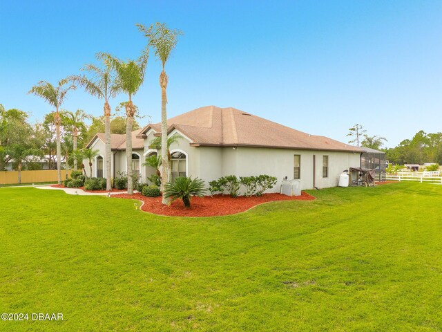 rear view of property featuring a yard