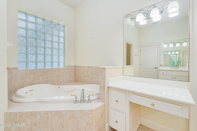 bathroom with vanity, a bath, and visible vents