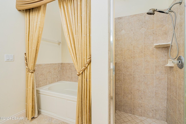 bathroom with tile patterned floors, a bath, and a stall shower