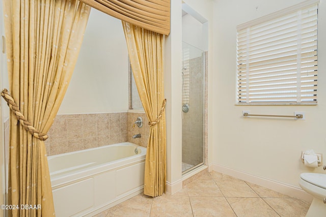 full bath with tile patterned floors, toilet, a shower stall, baseboards, and a bath