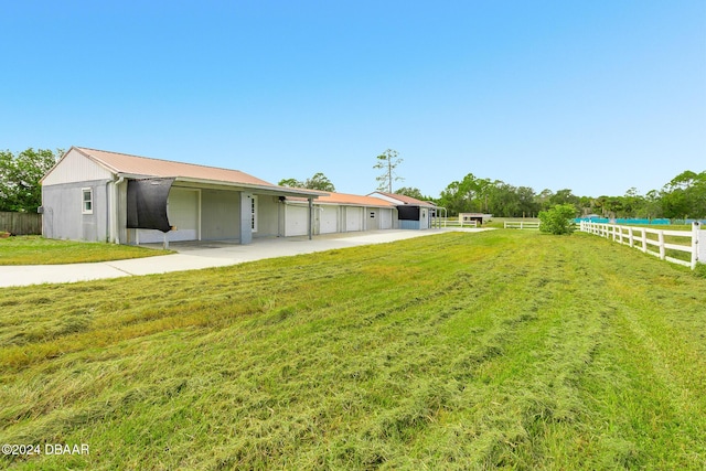 view of yard with community garages and an outbuilding