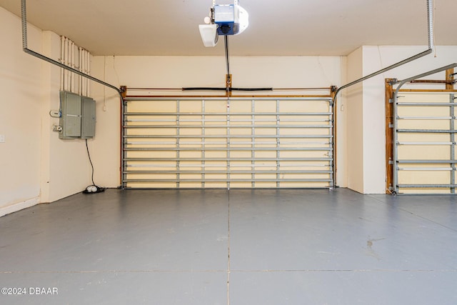 garage featuring electric panel and a garage door opener