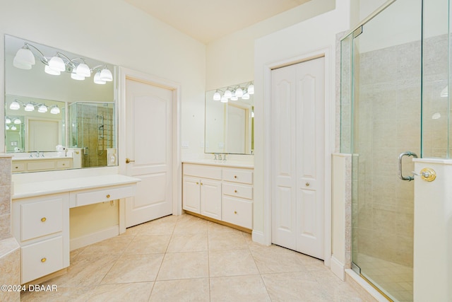 bathroom featuring vanity, tile patterned floors, and a stall shower