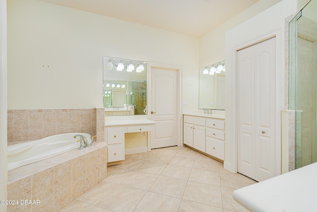 bathroom featuring tile patterned floors, a stall shower, vanity, and a bath