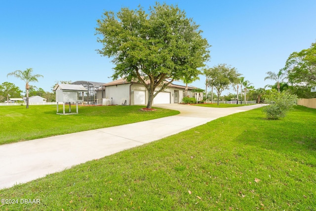 view of front of house featuring driveway, a front yard, and a garage