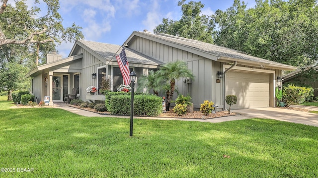 1885 Silver Fern Dr Unit 15, Port Orange, FL 32128 - view of front of home featuring a chimney, a garage, concrete driveway, roof with shingles, and a front lawn