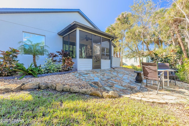 back of property featuring a sunroom, ceiling fan, and a patio area