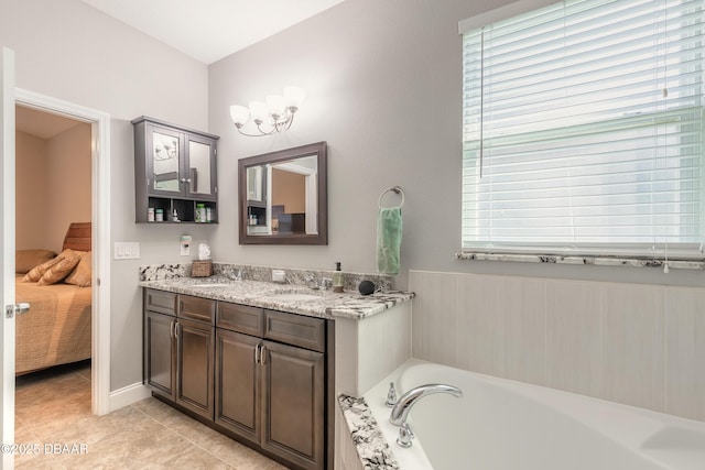 bathroom featuring a bath, vanity, tile patterned floors, and plenty of natural light