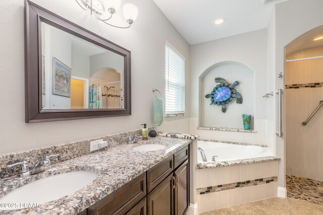 bathroom with tile patterned floors, vanity, and separate shower and tub