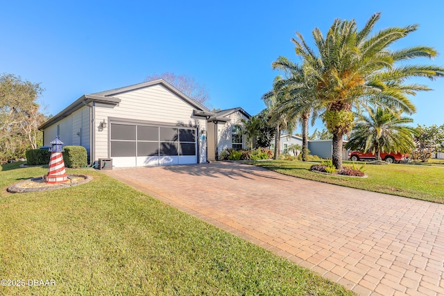 ranch-style home with a garage and a front lawn