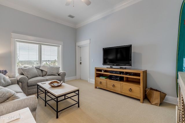 carpeted living room with ornamental molding and ceiling fan