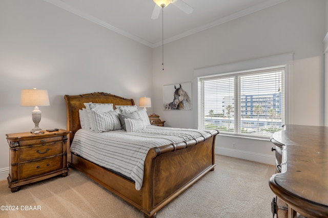 carpeted bedroom with ornamental molding and ceiling fan