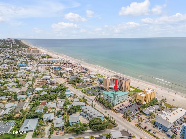 birds eye view of property featuring a beach view and a water view