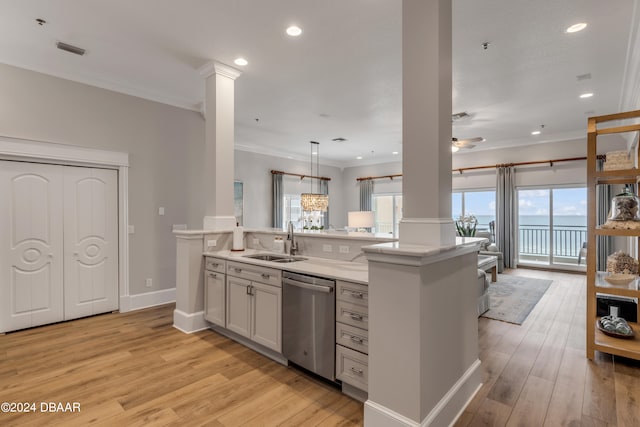 kitchen with dishwasher, hanging light fixtures, sink, and light hardwood / wood-style floors