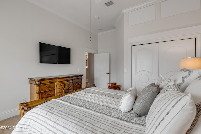 bedroom featuring carpet flooring, a closet, and ornamental molding