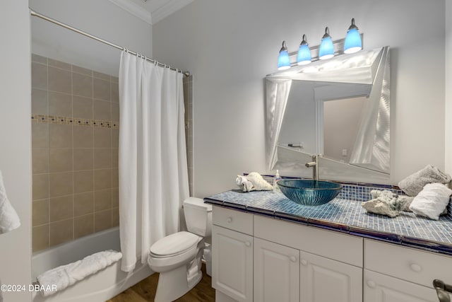 full bathroom featuring hardwood / wood-style flooring, vanity, shower / bath combo, crown molding, and toilet