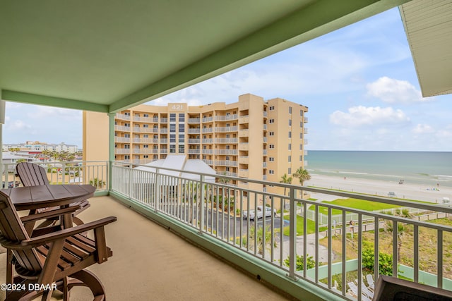 balcony featuring a water view and a beach view