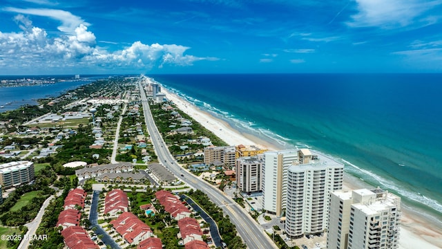 birds eye view of property with a water view and a beach view