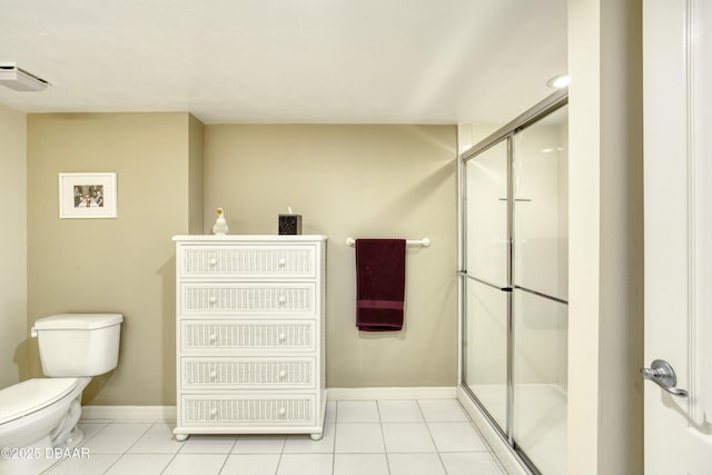 bathroom with tile patterned flooring, toilet, and a shower stall