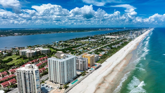 drone / aerial view featuring a water view and a view of the beach