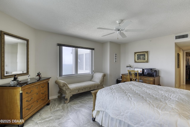 bedroom featuring a textured ceiling, visible vents, baseboards, and a ceiling fan