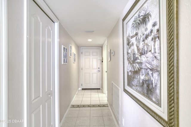 corridor with baseboards, recessed lighting, visible vents, and light tile patterned flooring