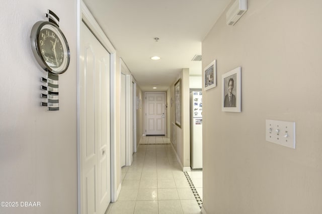 hall with light tile patterned floors, visible vents, baseboards, and recessed lighting