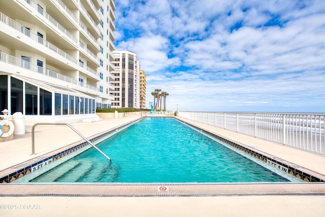 pool featuring a patio area and fence