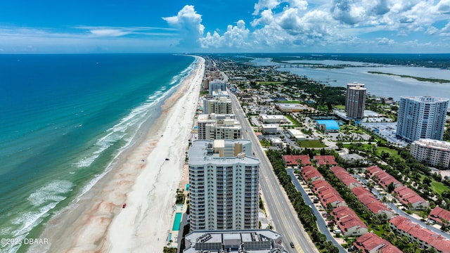 bird's eye view featuring a water view, a view of city, and a beach view
