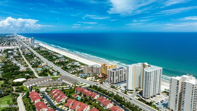 birds eye view of property with a beach view, a water view, and a city view