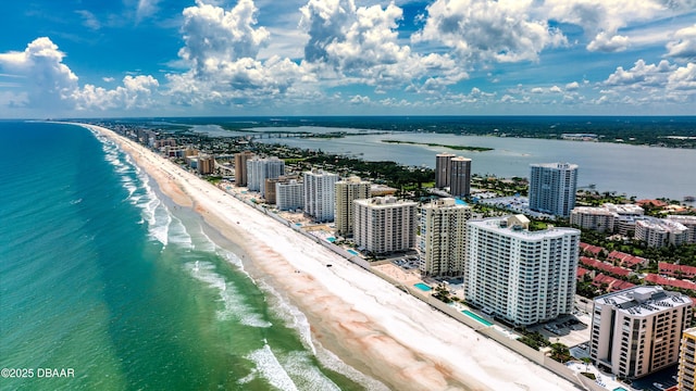 aerial view featuring a city view, a view of the beach, and a water view