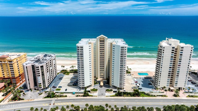 birds eye view of property featuring a beach view and a water view