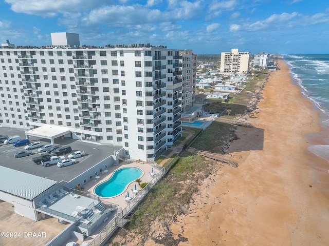 drone / aerial view featuring a water view and a view of the beach