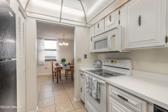 kitchen featuring pendant lighting, light tile patterned floors, white appliances, white cabinets, and a chandelier