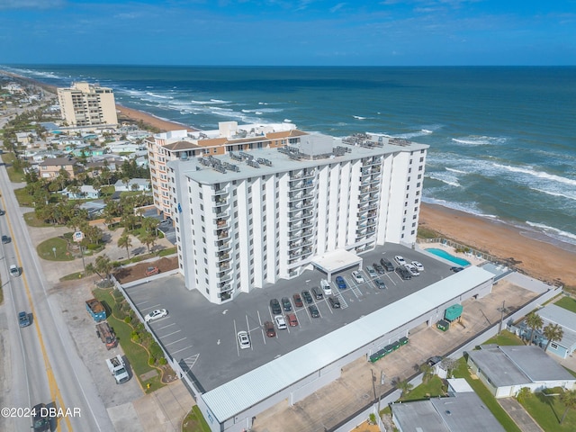 birds eye view of property with a water view and a view of the beach