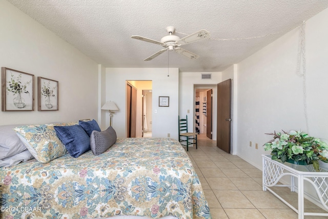 1415 Ocean Shore Blvd Unit 1111, Ormond Beach, FL 32176 - bedroom with light tile patterned flooring, a textured ceiling, and a ceiling fan