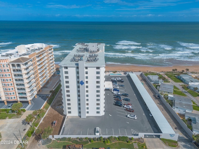 bird's eye view featuring a water view and a beach view