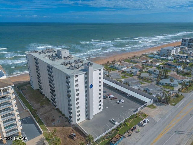 birds eye view of property featuring a water view and a beach view