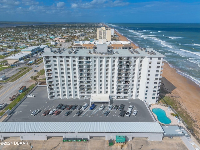 birds eye view of property featuring a water view and a beach view