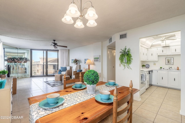 1415 Ocean Shore Blvd Unit 1111, Ormond Beach, FL 32176 - dining space with light tile patterned flooring, a ceiling fan, a chandelier, and a textured ceiling