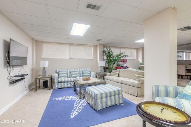 tiled living room with a drop ceiling