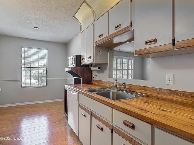 1104 Monticello Ln Unit 4, Port Orange, FL 32129 - kitchen with butcher block counters, a sink, a wealth of natural light, and dishwasher