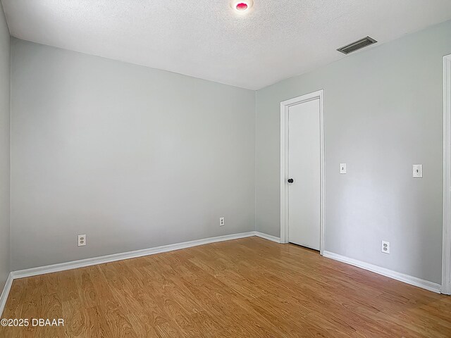 1104 Monticello Ln Unit 4, Port Orange, FL 32129 - spare room with baseboards, visible vents, and wood finished floors