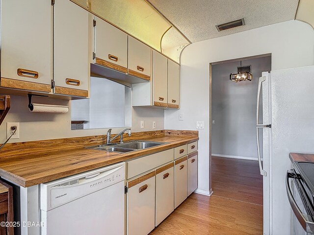 1104 Monticello Ln Unit 4, Port Orange, FL 32129 - kitchen featuring visible vents, white dishwasher, black range with electric stovetop, a sink, and light wood-style flooring