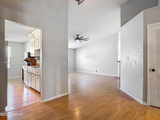 1104 Monticello Ln Unit 4, Port Orange, FL 32129 - interior space featuring light wood-style floors, baseboards, and a ceiling fan