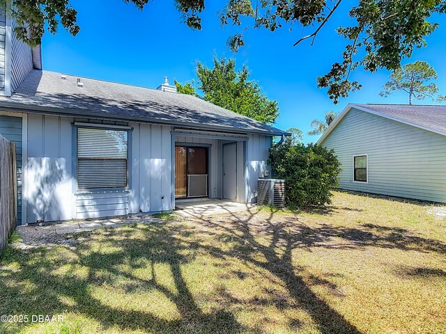 1104 Monticello Ln Unit 4, Port Orange, FL 32129 - rear view of property with a lawn, board and batten siding, and roof with shingles